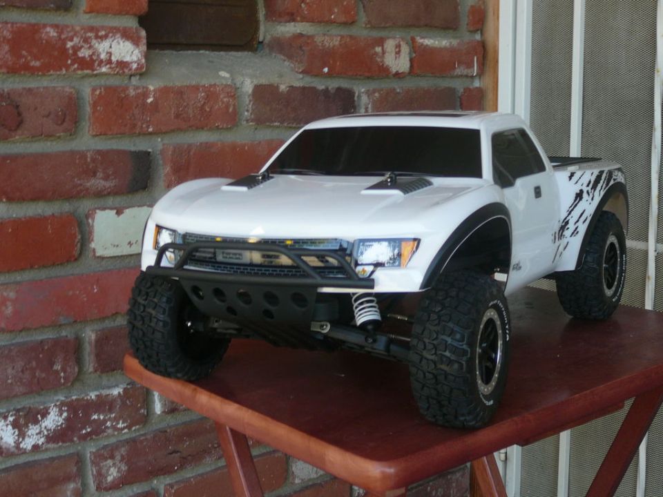 White remote control truck with black accents on a wooden table
