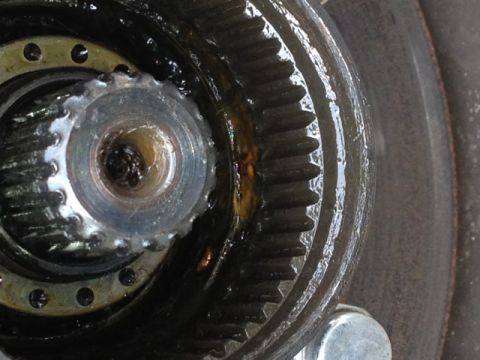 1979 Ford Bronco - A close-up view of a greasy front hub assembly, revealing intricate gears and splines.