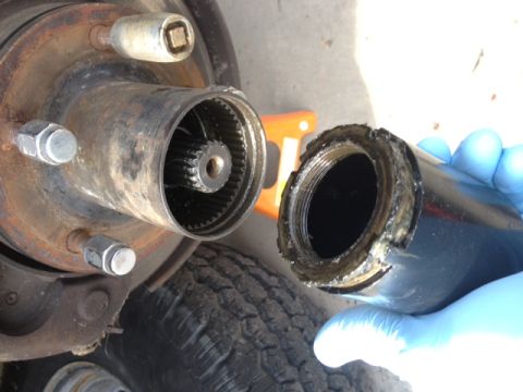 1979 Ford Bronco - Close-up of a front hub assembly showing internal splines and a damaged external component, likely from a Ford Bronco.