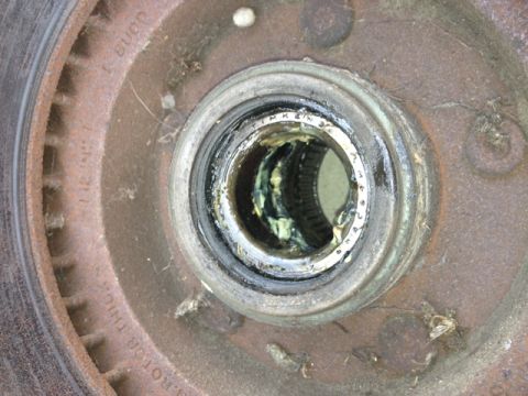 1979 Ford Bronco - Close-up of a front wheel hub assembly, showing the bearing and rotor markings.