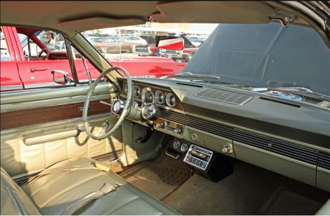 1966 Mercury Comet - The interior of a 1966 Mercury Comet shows off its classic dashboard and seating, with other vehicles visible outside.