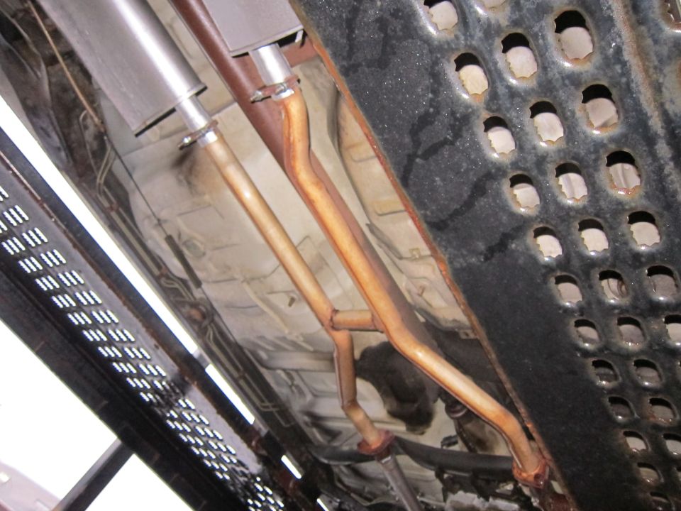 Undercarriage view of dual exhaust pipes and mufflers