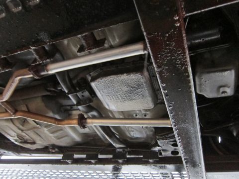 1991 Ford LTD Crown Victoria - Underside view of a vehicle's drivetrain components, including the transmission and exhaust system.