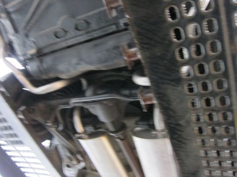 1991 Ford LTD Crown Victoria - Underside view of a vehicle's exhaust system and structural components.