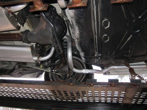 1991 Ford LTD Crown Victoria - Undercarriage view of a 1991 Ford Crown Victoria LTD, highlighting its rear suspension and exhaust components.
