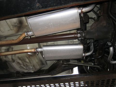 1991 Ford LTD Crown Victoria - Underside view of a vehicle's exhaust system, dual mufflers and a driveshaft.