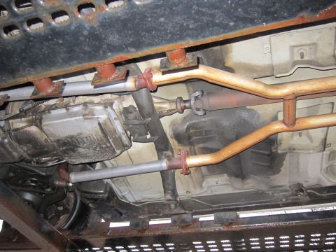 1991 Ford LTD Crown Victoria - Underside of a vehicle, focusing on the drivetrain and exhaust system components.