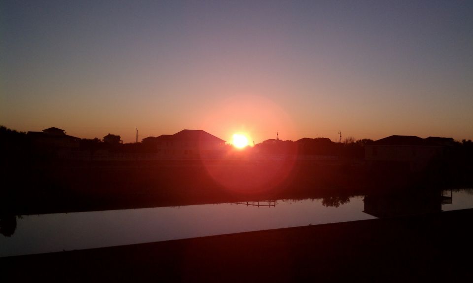Sunset over houses and a body of water