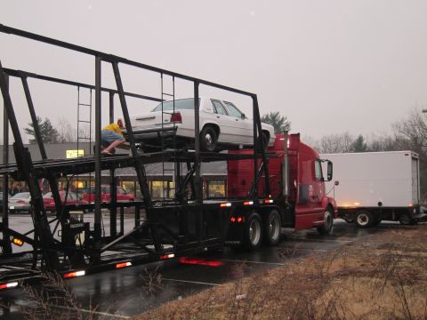 1991 Ford LTD Crown Victoria - White 1991 Ford Crown Victoria LTD loaded onto a car carrier truck.