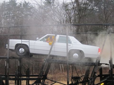1991 Ford LTD Crown Victoria - A white 1991 Ford Crown Victoria LTD is seen on a car carrier, with a driver visible inside.