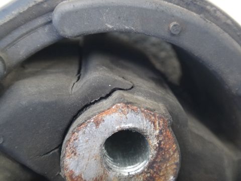 2003 Ford Taurus - Close-up of a damaged rubber motor mount, showing significant cracking.