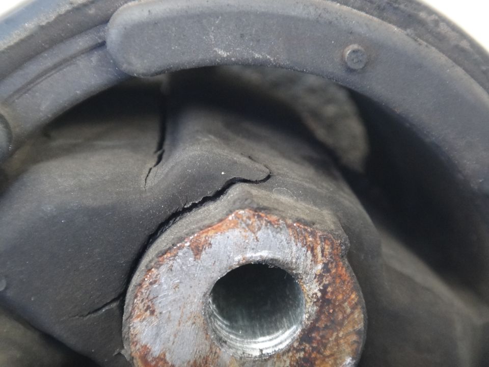 Cracked rubber motor mount with rusted metal bracket