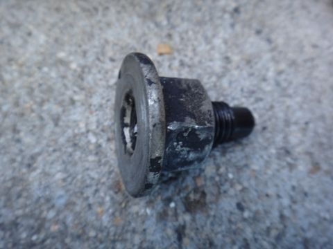 2003 Ford Taurus - A close-up view of a used motor mount bolt, showing wear and dirt from its previous application.