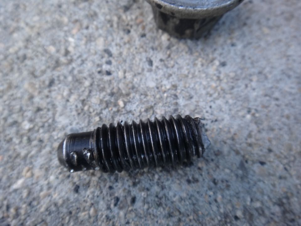 Stripped bolt and motor mount part on concrete