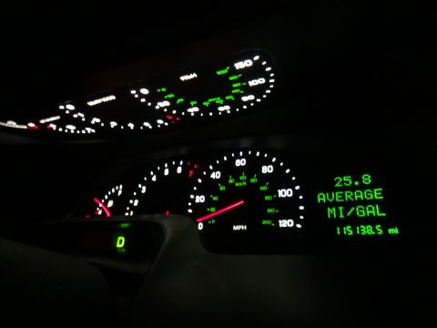2000 Lincoln Continental - Interior view of the dashboard gauges, displaying average fuel economy and total mileage.