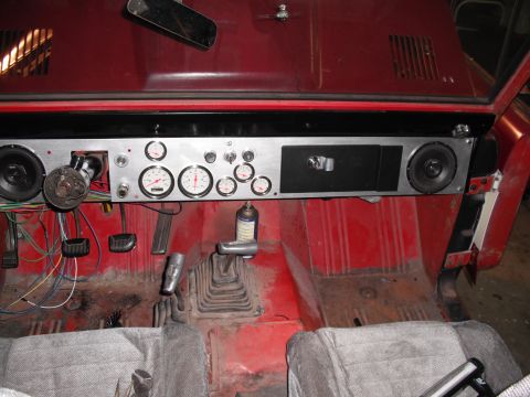 1968 Ford Bronco - Interior view of a 1968 Ford Bronco showing a custom dashboard with multiple gauges and speakers installed.