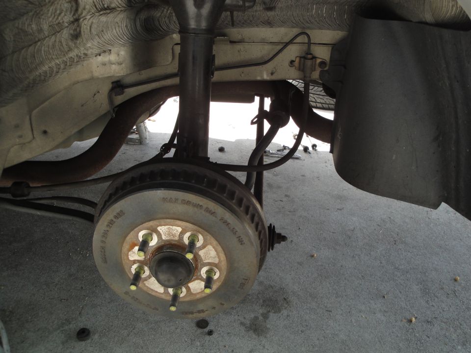 close-up of rear brake rotor and suspension components