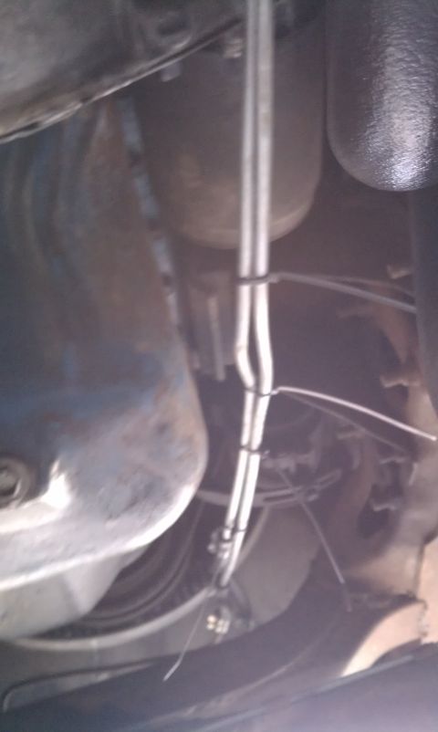 1979 Ford Bronco - Undercarriage view showing fuel lines and exhaust system components.