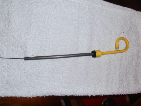 1990 Ford Bronco - A yellow-handled oil dipstick is shown lying on a white towel.