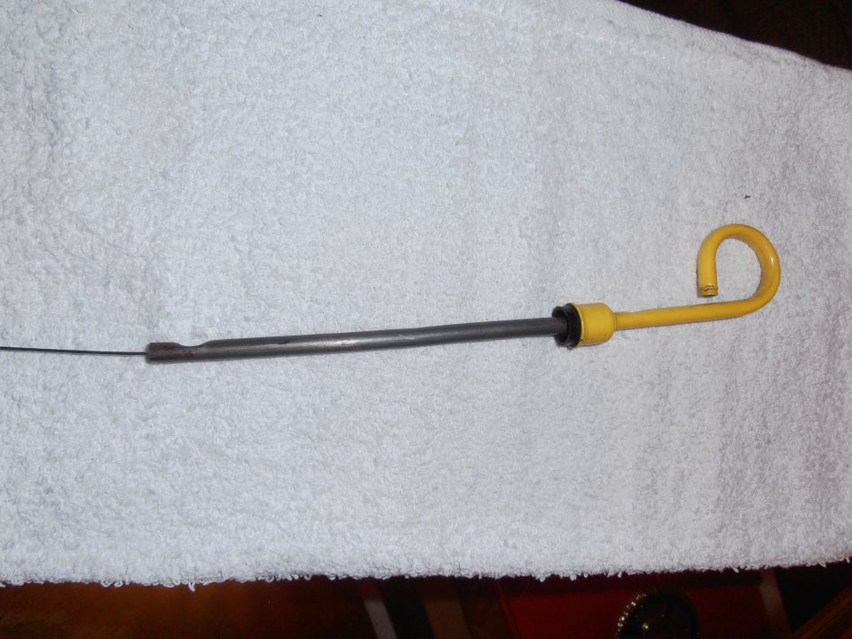 yellow-handled oil dipstick on a white towel