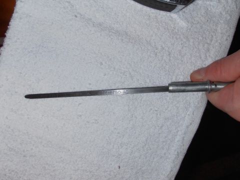 1990 Ford Bronco - An oil dipstick with the part number E9TE-6750-AC is held over a white towel.