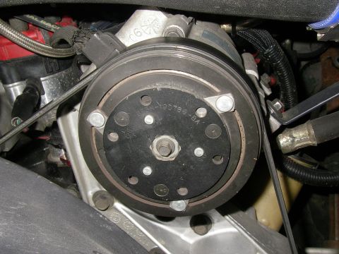 1990 Ford Bronco - Close-up view of an air conditioning compressor clutch, showing a part number.