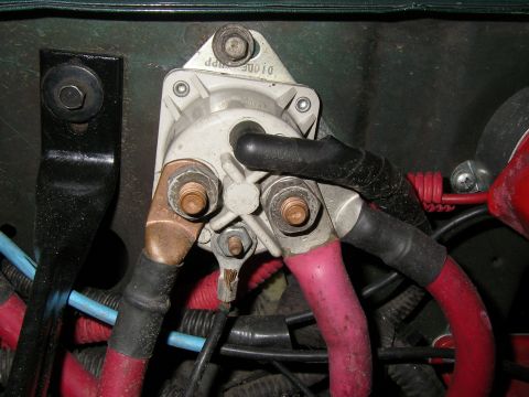 1990 Ford Bronco - Close-up of a vehicle's starter solenoid and associated wiring connections.