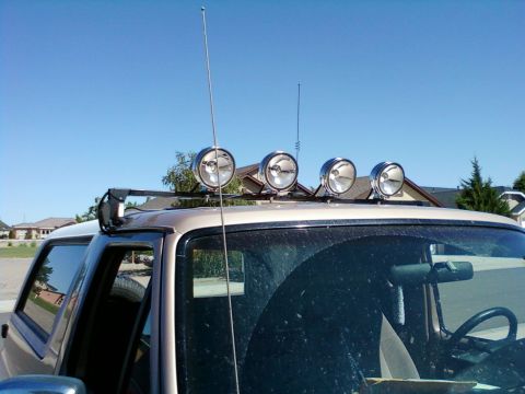 1996 Ford Bronco - The vehicle's roof is equipped with four auxiliary lights and two antennas, suggesting off-road or communication modifications.