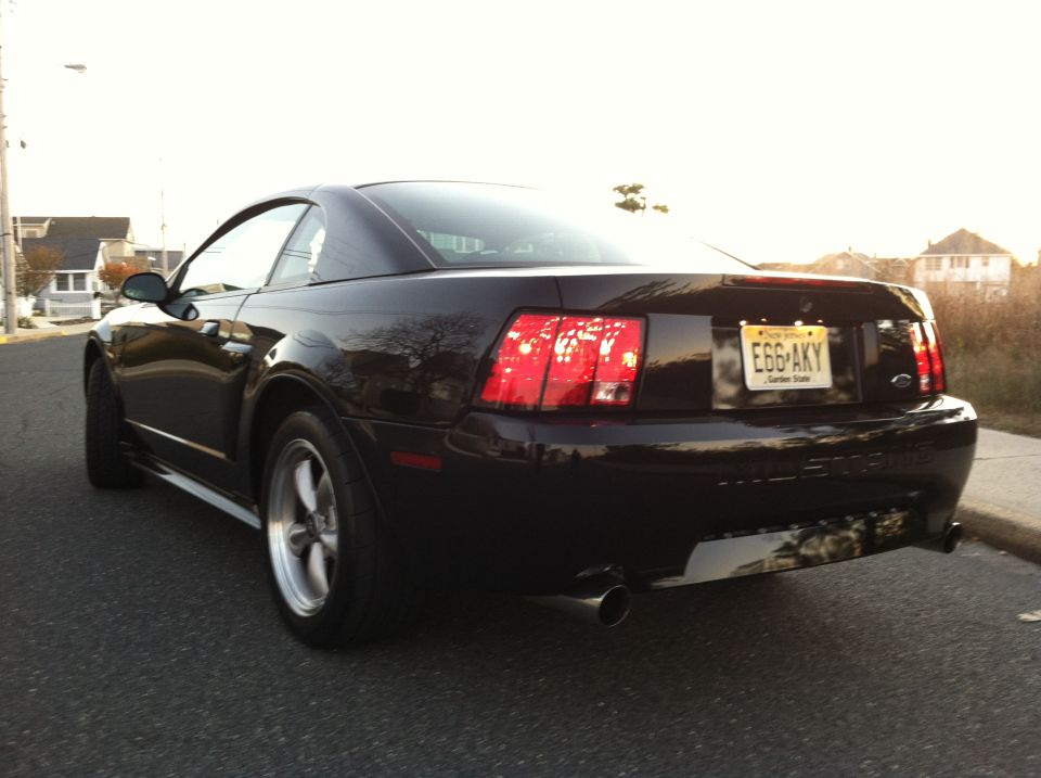 Dark Ford Mustang coupe, rear driver's side view, New Jersey license plate E66-AKY.