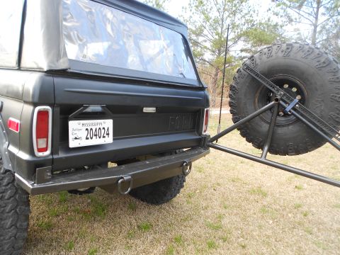 1967 Ford Mustang - Rear view of a black early Ford Bronco with a tailgate reading 'FORD' and a Mississippi Antique Car plate '204024', featuring a rear steel…