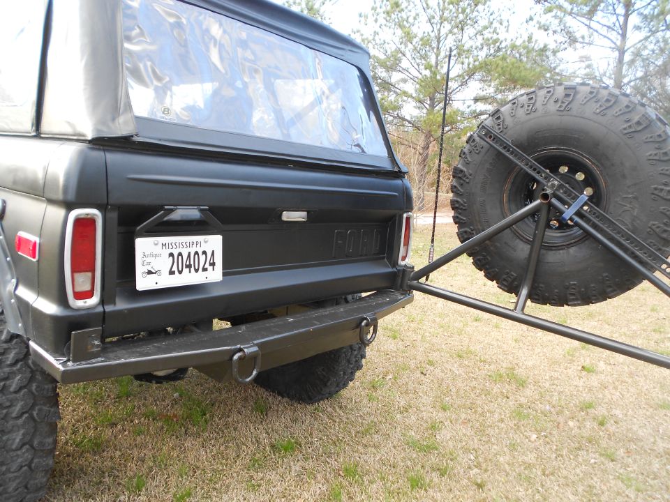Rear of black Ford Bronco with Mississippi plate and swing-out spare tire carrier