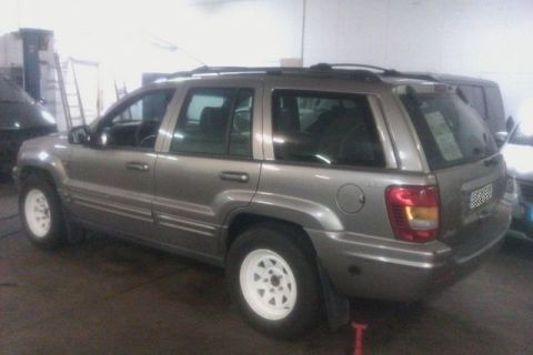 1991 Ford Crown Victoria - This Jeep Grand Cherokee is seen from the rear three-quarter view in an indoor setting.
