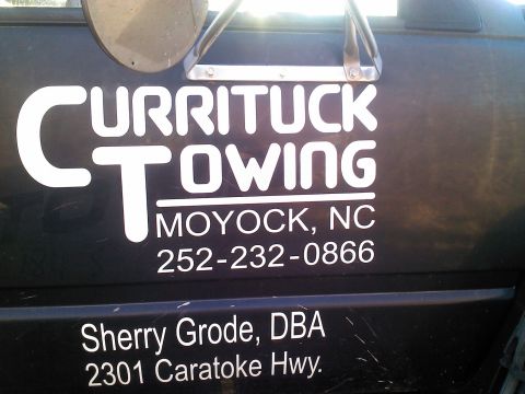 1979 Ford Bronco - Vehicle side displays towing company information and an address.
