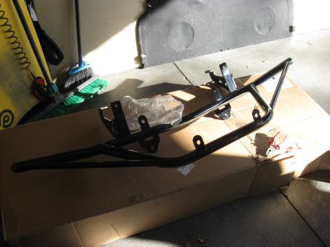 1995 Ford F-150 - A black metal light bar part is shown resting on a cardboard box, with cleaning supplies in the background.
