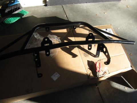 1995 Ford F-150 - Off-road light bar with mounting hardware, placed on a cardboard box in a garage.