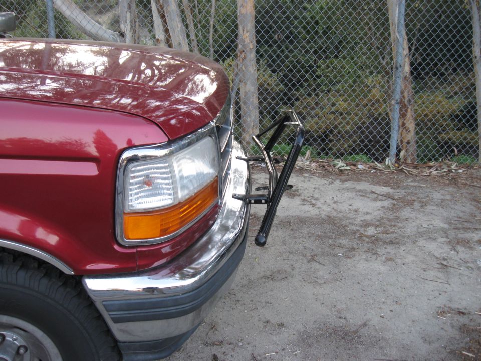 Red 1995 Ford F-150 front with light bar
