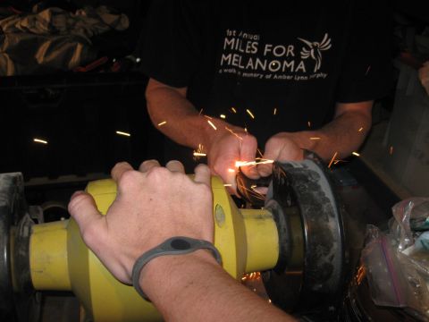 1995 Ford F-150 - Grinding metal sparks fly as a person works on a part with a grinder.
