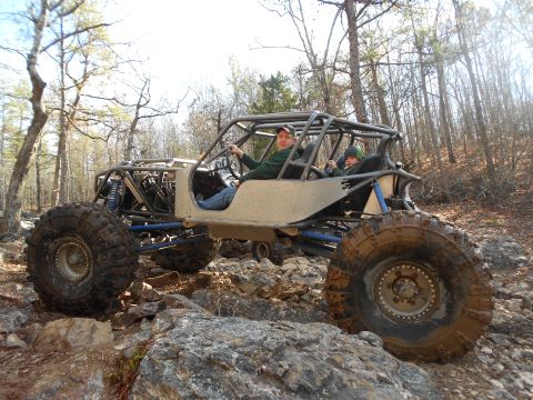 1967 Ford Mustang - A custom-built buggy navigates a rocky trail with two occupants.