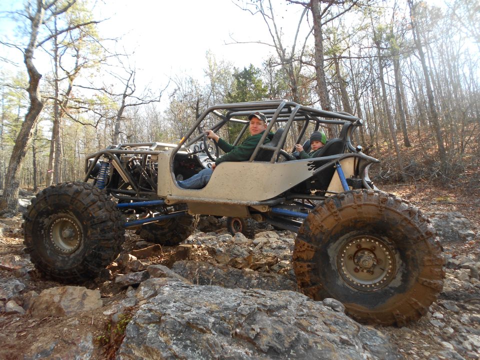 Custom buggy with large tires on rocky terrain