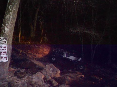1967 Ford Mustang - A white off-road buggy navigates a challenging rocky terrain in the dark.