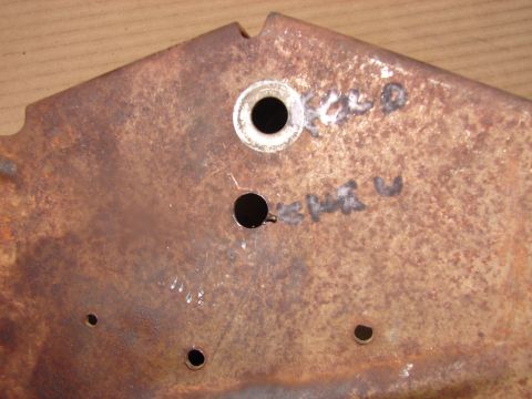 1973 Ford Ranchero - Close-up of a rusty metal bracket, possibly a vehicle part, with handwritten markings.