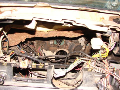 1973 Ford Ranchero - The complex wiring and exposed components of a vehicle's interior dashboard are visible in this image.