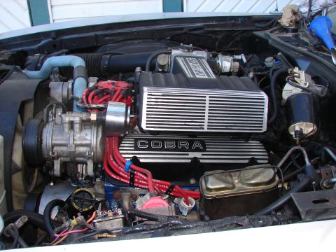 1973 Ford Ranchero - Engine bay features COBRA valve covers and a GT-40 intake manifold, suggesting a performance-oriented Ford vehicle.