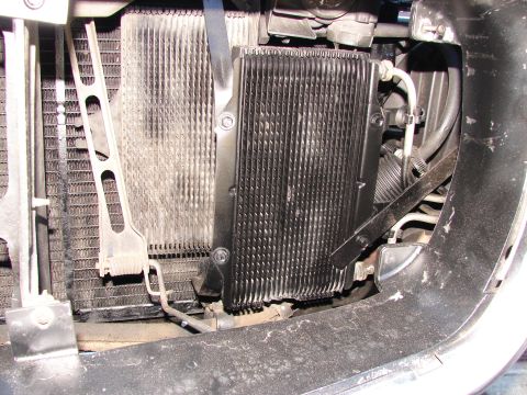 1973 Ford Ranchero - Close-up view of a transmission cooler and radiator assembly, showing hoses and mounting hardware.