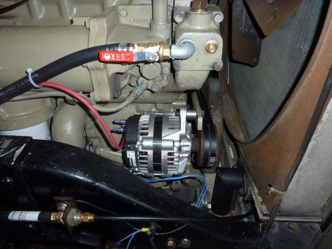 1959 Kenworth W900A - Close-up view of an alternator and engine components, showing hoses and wiring.