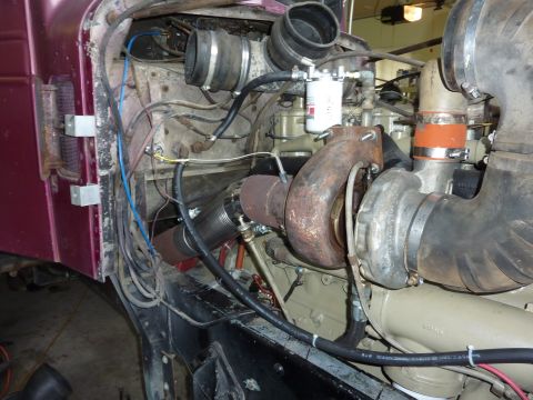 1959 Kenworth W900A - The engine compartment of a truck is shown, focusing on the turbocharger and intake system.