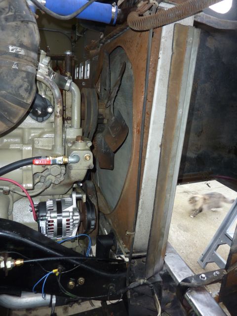 1959 Kenworth W900A - Close-up view of a truck's engine compartment, showing the alternator and radiator assembly.