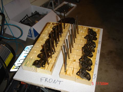 1995 Ford Bronco - Engine valve train components are laid out and organized on wooden blocks for assembly or inventory.
