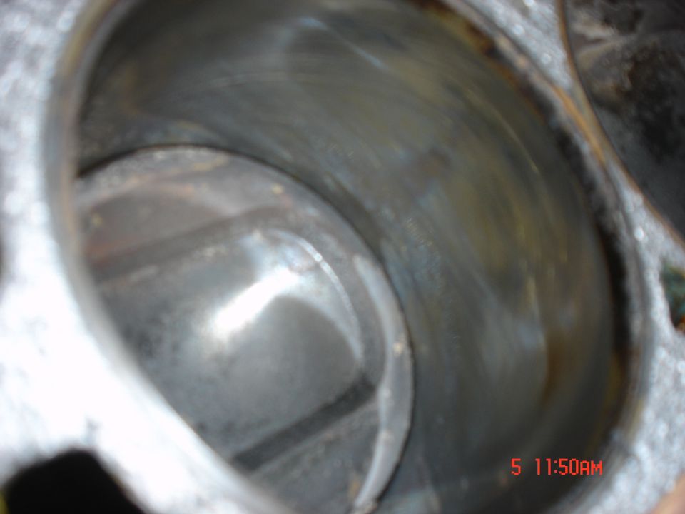 Close-up of an engine cylinder bore with visible honing marks and some discoloration