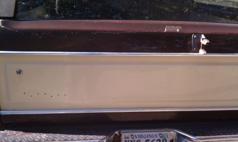 1979 Ford Bronco - Close-up of the tailgate on a 1979 Ford Bronco, showing its two-tone paint scheme and a Virginia license plate.